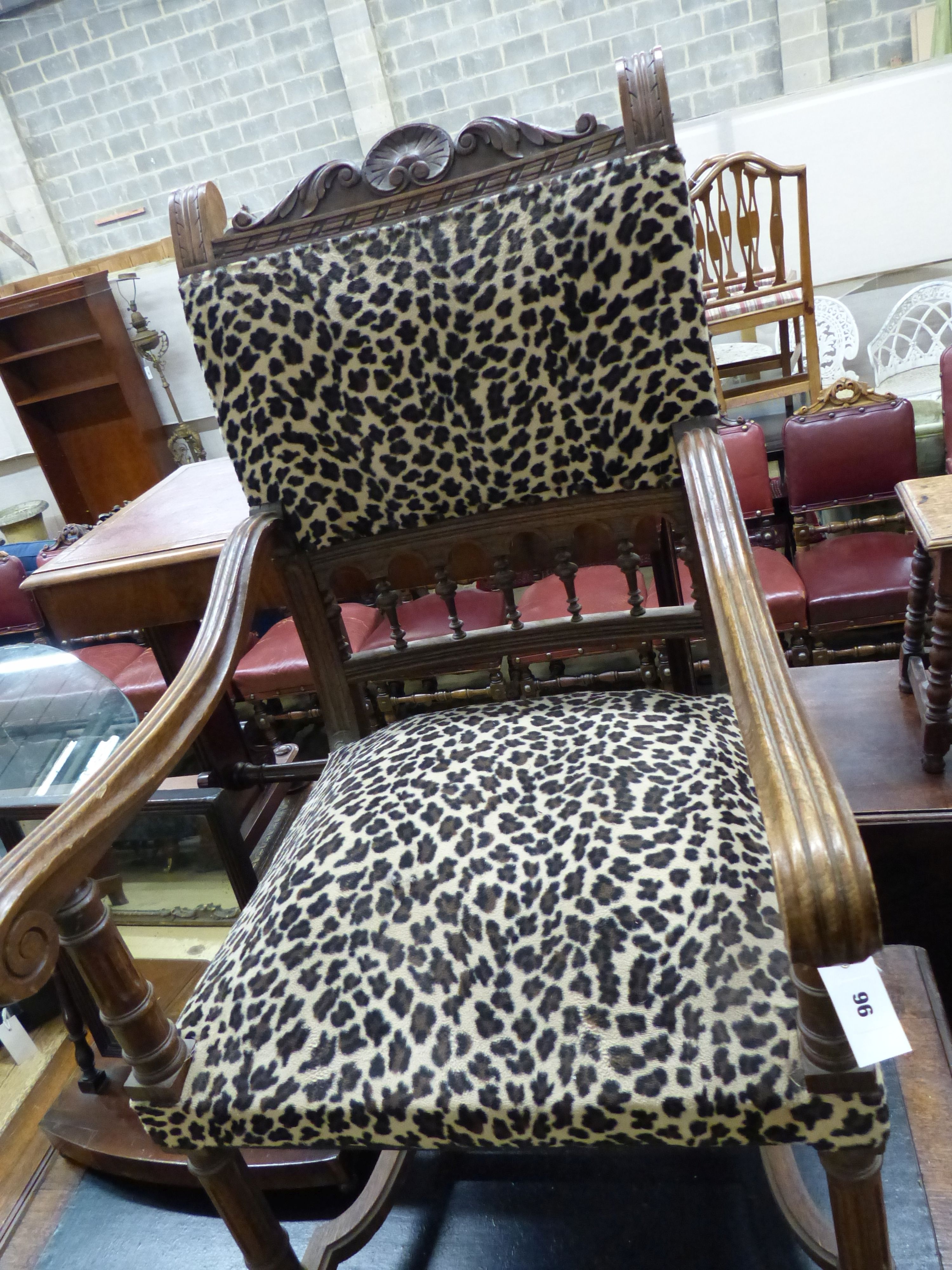 A late 19th century leopard print upholstered wooden elbow chair and a mahogany toilet mirror